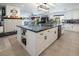 Open kitchen features large island with sink, seating, and white cabinetry at 2870 Belcastro St, Las Vegas, NV 89117
