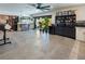 Spacious living room with a custom bar, tile flooring, and lots of natural light at 2870 Belcastro St, Las Vegas, NV 89117