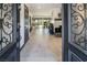Elegant foyer leading to a spacious living area featuring tile floors and abundant natural light at 2870 Belcastro St, Las Vegas, NV 89117