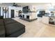 Open-concept living space featuring a decorative fireplace, comfortable seating, and an open kitchen at 2870 Belcastro St, Las Vegas, NV 89117