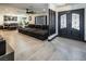 Spacious living area with tile floors, a large sectional sofa and decorative columns at 2870 Belcastro St, Las Vegas, NV 89117