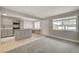 Cozy living room features gray walls, carpet, and a view of the modern kitchen at 304 Orland St # 38, Las Vegas, NV 89107