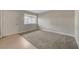 Neutral living room with gray carpet, a window, and a modern front door at 304 Orland St # 38, Las Vegas, NV 89107