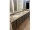 Bathroom featuring a double sink vanity with granite countertop and gray cabinets at 3417 Iberia St, Las Vegas, NV 89146