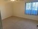 Inviting bedroom with plush carpeting, a ceiling fan, and a large window offering plenty of natural light at 3417 Iberia St, Las Vegas, NV 89146