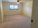 Bright bedroom with neutral carpeting, a ceiling fan, and natural light, creating a cozy and comfortable space at 3417 Iberia St, Las Vegas, NV 89146