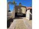 Driveway with an RV car port, open gate, gravel, and a palm tree at 3417 Iberia St, Las Vegas, NV 89146
