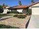 Front exterior of a home featuring colorful bushes, manicured lawn, and a wrought iron gate at 3417 Iberia St, Las Vegas, NV 89146