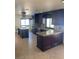 Beautiful kitchen featuring dark wood cabinetry, granite countertops, stainless steel appliances, and a functional center island at 3417 Iberia St, Las Vegas, NV 89146