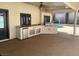 Inviting outdoor kitchen area complete with a built-in grill, mini fridge, and ample counter space for entertaining at 3417 Iberia St, Las Vegas, NV 89146
