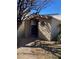 Backyard shed with a round window, door, walkway, and a gravel yard at 3417 Iberia St, Las Vegas, NV 89146