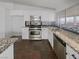 Well-equipped kitchen featuring stainless steel appliances, granite countertops, and white cabinets at 350 Loma Marsh Ct, North Las Vegas, NV 89084