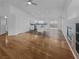 Open-concept living space with wood floors flowing into the kitchen and fireplace feature at 350 Loma Marsh Ct, North Las Vegas, NV 89084