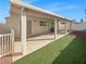 Enjoy outdoor living with this covered patio and well-maintained artificial turf, perfect for entertaining at 350 Loma Marsh Ct, North Las Vegas, NV 89084