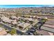 An aerial view shows a neighborhood street with well-manicured lawns near mountain views in the background at 370 Mano Destra Ln, Henderson, NV 89011
