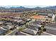 An aerial view features a neighborhood near a school with an athletic field and mountains in the background at 370 Mano Destra Ln, Henderson, NV 89011
