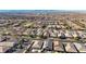 A wide aerial view shows a community of homes with desert landscaping in the foreground with mountain views in the distance at 370 Mano Destra Ln, Henderson, NV 89011