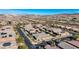 An aerial view shows a neighborhood street with well-manicured lawns near mountain views in the background at 370 Mano Destra Ln, Henderson, NV 89011
