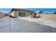 Wide backyard view highlighting the concrete patio and surrounding privacy fence at 370 Mano Destra Ln, Henderson, NV 89011