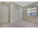 Well-lit bedroom featuring carpeted floors, a double door closet, and a window at 370 Mano Destra Ln, Henderson, NV 89011