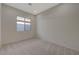 Neutral carpeted bedroom featuring natural light from a window providing a bright and airy atmosphere at 370 Mano Destra Ln, Henderson, NV 89011