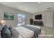 Virtually staged bedroom featuring neutral decor, backyard access, and a television at 370 Mano Destra Ln, Henderson, NV 89011