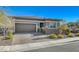Beautiful one-story home featuring desert landscaping, a two-car garage, and a charming front entrance at 370 Mano Destra Ln, Henderson, NV 89011