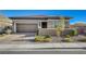 Beautiful one-story home featuring desert landscaping, a two-car garage, and a charming front entrance at 370 Mano Destra Ln, Henderson, NV 89011