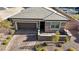 Charming single-story home with a brick driveway, stone accents, and a well-manicured front yard at 370 Mano Destra Ln, Henderson, NV 89011