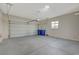 Spacious garage featuring a large door, concrete floors, and ample storage space at 370 Mano Destra Ln, Henderson, NV 89011