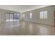Bright, open living room with tile flooring and sliding glass doors to the backyard at 370 Mano Destra Ln, Henderson, NV 89011