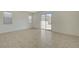 Spacious living room with ceramic tile flooring and sliding glass doors to the patio at 370 Mano Destra Ln, Henderson, NV 89011