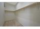 Walk-in closet with carpeted floors and a wooden clothing rod at 370 Mano Destra Ln, Henderson, NV 89011