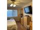 Bedroom with wood laminate flooring, closet, chest of drawers, and a ceiling fan at 3748 E Hacienda Ave, Las Vegas, NV 89120