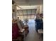 Open garage with a partially raised door and an array of stored items at 3748 E Hacienda Ave, Las Vegas, NV 89120
