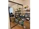 Cluttered room with multiple mirrors, wood laminate flooring, and built-in shelves at 3748 E Hacienda Ave, Las Vegas, NV 89120
