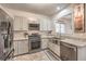 Bright kitchen featuring stainless steel appliances, granite countertops, and ample cabinet space at 3916 Otter Corner Ct, Las Vegas, NV 89122