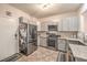 View of kitchen showcasing stainless steel appliances, granite countertops, and light gray cabinets at 3916 Otter Corner Ct, Las Vegas, NV 89122