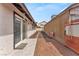 Backyard area with a stone pathway, sliding glass door, and a private outdoor space at 4153 Broadriver Dr, Las Vegas, NV 89108