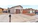 Inviting single-story home featuring a spacious driveway and desert landscaping at 4153 Broadriver Dr, Las Vegas, NV 89108
