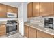 Efficient kitchen with a modern oven, microwave, and granite countertops for easy cooking at 4153 Broadriver Dr, Las Vegas, NV 89108