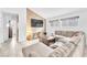 Cozy living room with a fireplace, plush sofa, and tile flooring at 4153 Broadriver Dr, Las Vegas, NV 89108