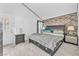 Main bedroom featuring a statement wall, large bed, and tiled floors at 4153 Broadriver Dr, Las Vegas, NV 89108