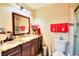 Cozy bathroom featuring a granite countertop, dark wood vanity, and decorative towels at 4735 Monterrey Ave, Las Vegas, NV 89121