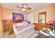 Bedroom with light peach-colored walls, ceiling fan, wood floors, and traditional furniture at 4735 Monterrey Ave, Las Vegas, NV 89121