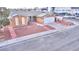 Charming single-story home with a gravel yard, solar panels, and a paved driveway leading to a two-car garage at 4735 Monterrey Ave, Las Vegas, NV 89121