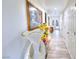 Hallway with tile floors, white walls, and decorative vases, leading to a bright, open space at 4735 Monterrey Ave, Las Vegas, NV 89121