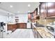Open kitchen with granite countertops, stainless steel appliances, and wood cabinets, perfect for cooking at 4735 Monterrey Ave, Las Vegas, NV 89121