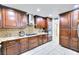 Elegant kitchen with dark wood cabinetry, stainless steel appliances, granite countertops, and tile backsplash at 4735 Monterrey Ave, Las Vegas, NV 89121