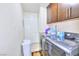 Functional laundry room with modern washer and dryer units and ample cabinet space at 4735 Monterrey Ave, Las Vegas, NV 89121